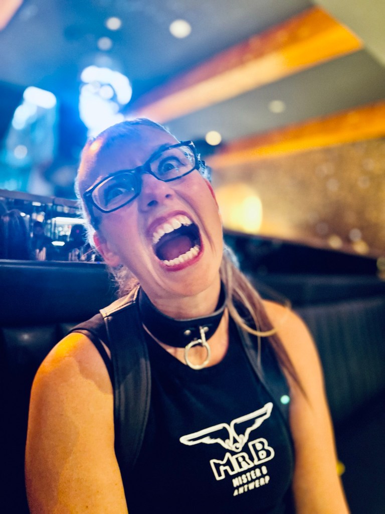 Lynne mid-shout in a bar